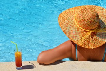 Woman enjoying a drink by the pool
